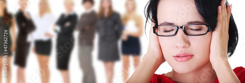 Photo: Frustrated young woman holding her ears Frustrated young woman holding her ears