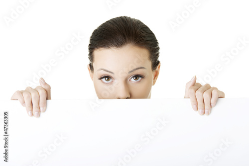 Photo: Portrait young happy woman with blank board Portrait young happy woman with blank board