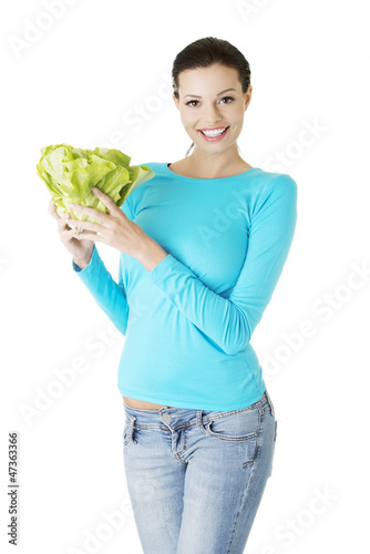 Photo: Attractive smiling woman with fresh salat Attractive smiling woman with fresh salat