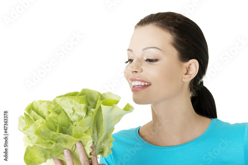 Photo: Attractive smiling woman with fresh salat Attractive smiling woman with fresh salat
