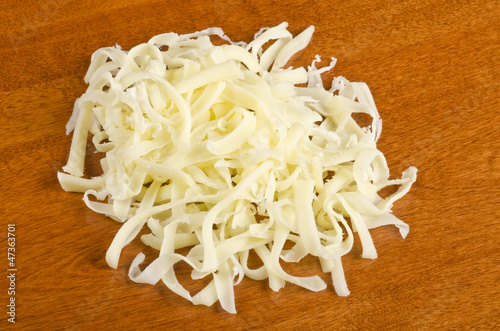 Photo: Shredded Mozzarella Cheese on a Table Top Shredded Mozzarella Cheese on a Table Top