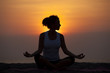 Slim woman meditating in pose lotus at evening