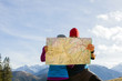Photo: Couple hiking with map in mountains Couple hiking with map in mountains