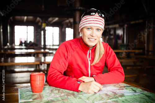 Photo: Woman hiker with map planning trip Woman hiker with map planning trip