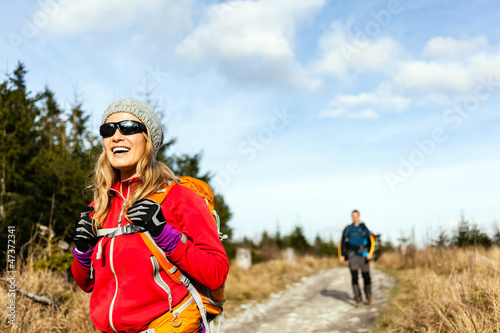 Photo: Couple walking and hiking on mountain trail Couple walking and hiking on mountain trail
