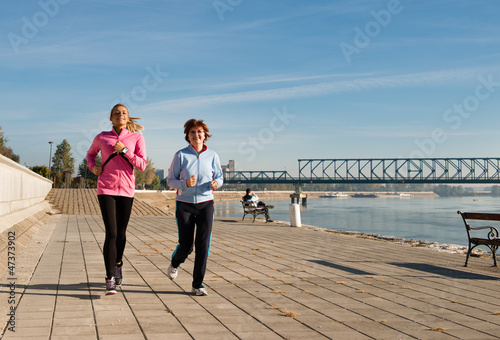 Photo: Mother and daughter jogging on coasts Mother and daughter jogging on coasts