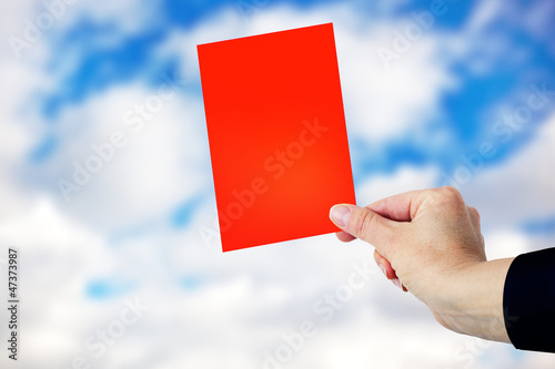 Photo: Hand showing red card Hand showing red card