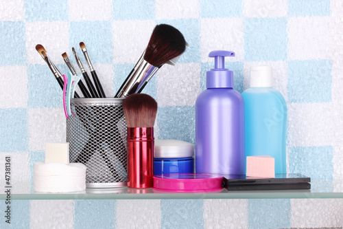Photo: Shelf with cosmetics and toiletries in bathroom Shelf with cosmetics and toiletries in bathroom