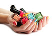 woman hands with nail polishes isolated on white
