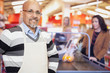 Photo: Grocery Store Cashier Standing At Checkout Counter Grocery Store Cashier Standing At Checkout Counter