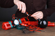 Human makes timebomb on wooden table on black background