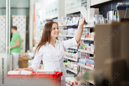 Photo: Pharmacist Stocking Shelves Pharmacist Stocking Shelves