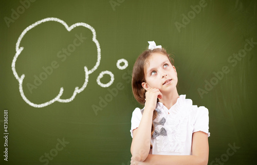 Photo: Scoolgirl standing near blackboard Scoolgirl standing near blackboard