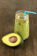 Useful fresh avocado and half avocado on wooden table close-up