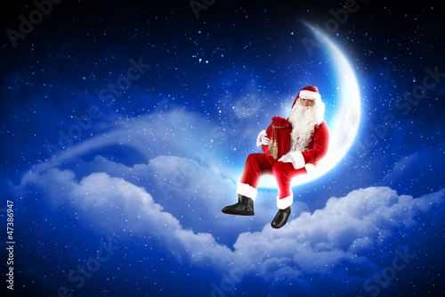 Photo: photo of santa claus sitting on the moon photo of santa claus sitting on the moon