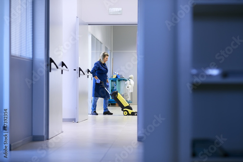 Photo: Women at workplace, professional female cleaner washing floor in Women at workplace, professional female cleaner washing floor in