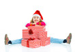 Little girl in Santa's hat with gift box