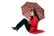 Scottish woman sitting with umbrellas