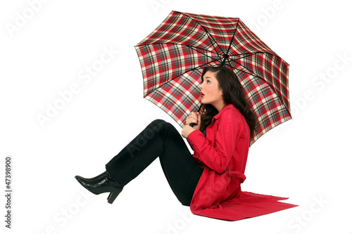 Photo: Scottish woman sitting with umbrellas Scottish woman sitting with umbrellas