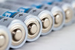 Several AA batteries in perspective closeup view on white