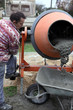 Photo: Builder using a cement mixer Builder using a cement mixer