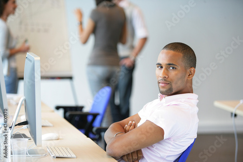 Photo: Man sitting back in an office Man sitting back in an office