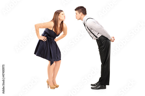 Photo: Full length portrait of a heterosexual couple about to kiss Full length portrait of a heterosexual couple about to kiss