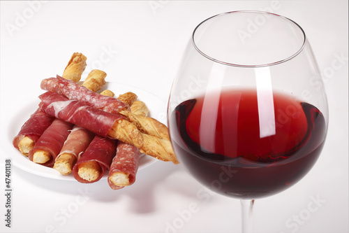 Photo: Glass of red wine and biscuits with bacon Glass of red wine and biscuits with bacon