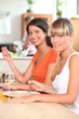 Two female housemates eating at home