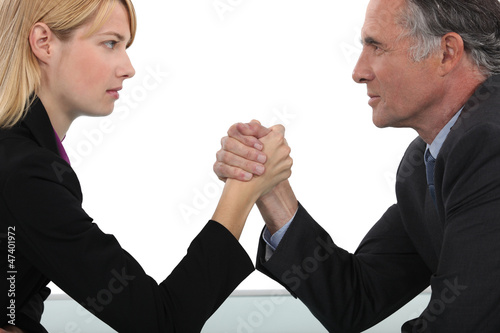 Photo: Boss and employee having an arm wrestle Boss and employee having an arm wrestle