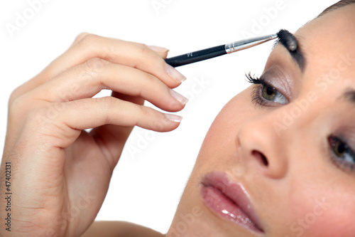 Photo: Woman applying make-up Woman applying make-up