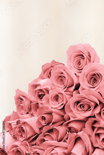 Photo: Bouquet of roses on a faded background paper Bouquet of roses on a faded background paper