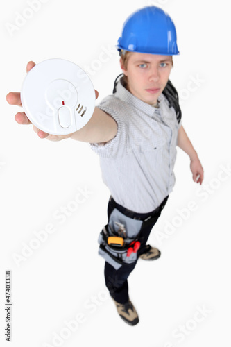 Photo: Builder holding smoke alarm Builder holding smoke alarm