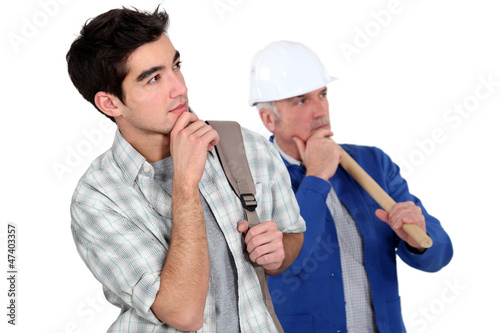 Photo: Builder stood with young apprentice Builder stood with young apprentice