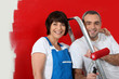 Couple painting wall red
