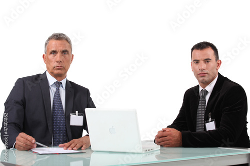 Photo: Couple of executives with computer Couple of executives with computer