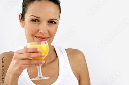 Photo: Woman having refreshing glass of orange juice Woman having refreshing glass of orange juice