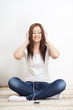 Foto: woman sitting on carpet and listen to the music woman sitting on carpet and listen to the music