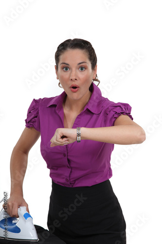Photo: young housewife open-mouthed in surprise glancing at watch young housewife open-mouthed in surprise glancing at watch