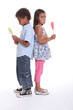 a little boy and a little girl pouting and eating ice cream