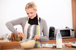 blonde woman making a cake