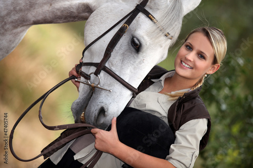 Photo: Young woman with her horse Young woman with her horse