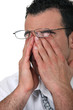 Tired man wearing glasses