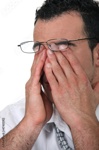 Photo: Tired man wearing glasses Tired man wearing glasses