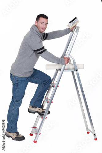 Photo: Man putting up wallpaper Man putting up wallpaper