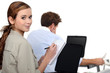 female employee writing notes near a colleague