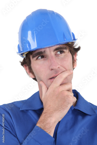 Photo: A pensive manual worker. A pensive manual worker.