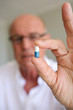 Elderly man taking his medication