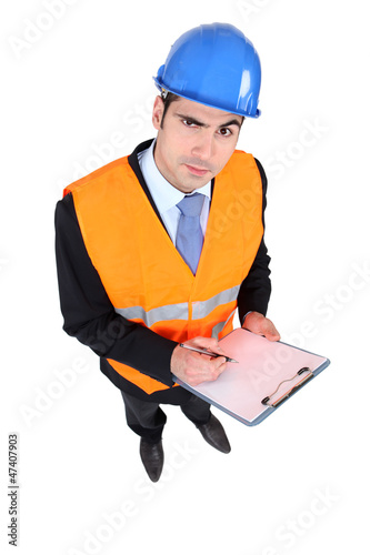 Photo: Architect stood with clipboard Architect stood with clipboard