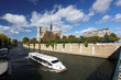 Notre Dame with boat on Seine in Paris, France